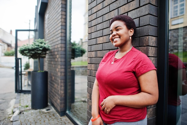 African woman wear red tshirt posing outdoor