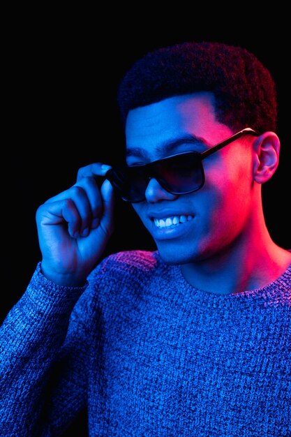 Africanamerican man's portrait isolated on black studio background in multicolored neon light