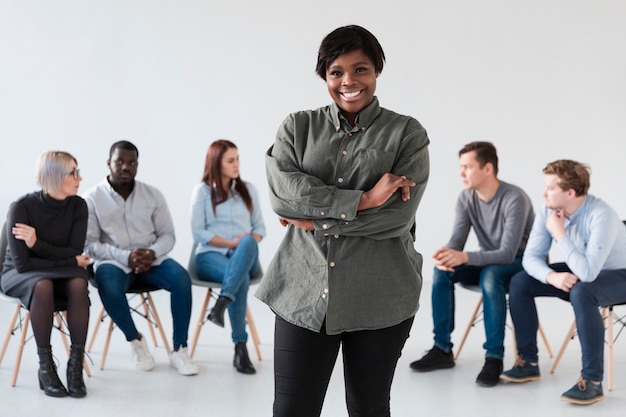 Afro-american female standing in front of rehab patients