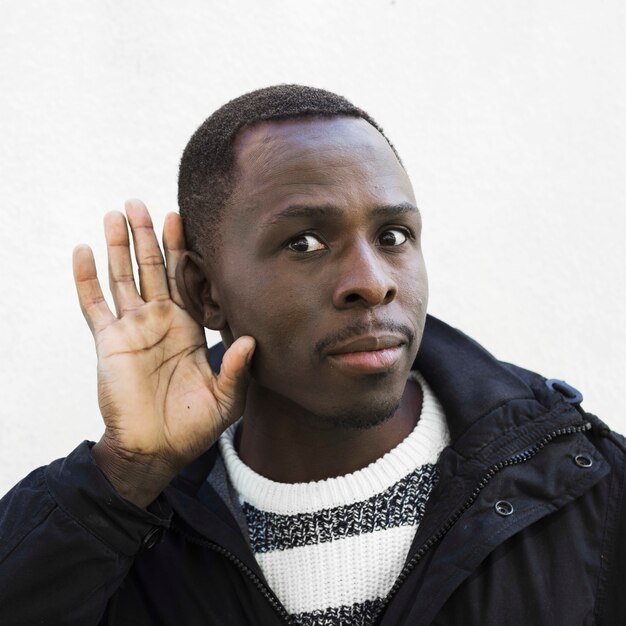 Afro american man doing listen gesture