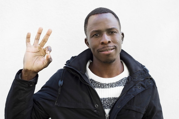 Free photo afro american man doing ok gesture