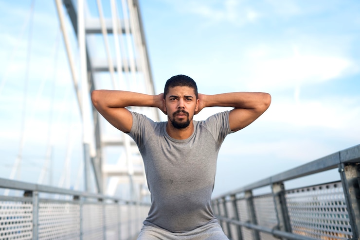 Free Photo afro american sportsman warming up his body for an outdoor training