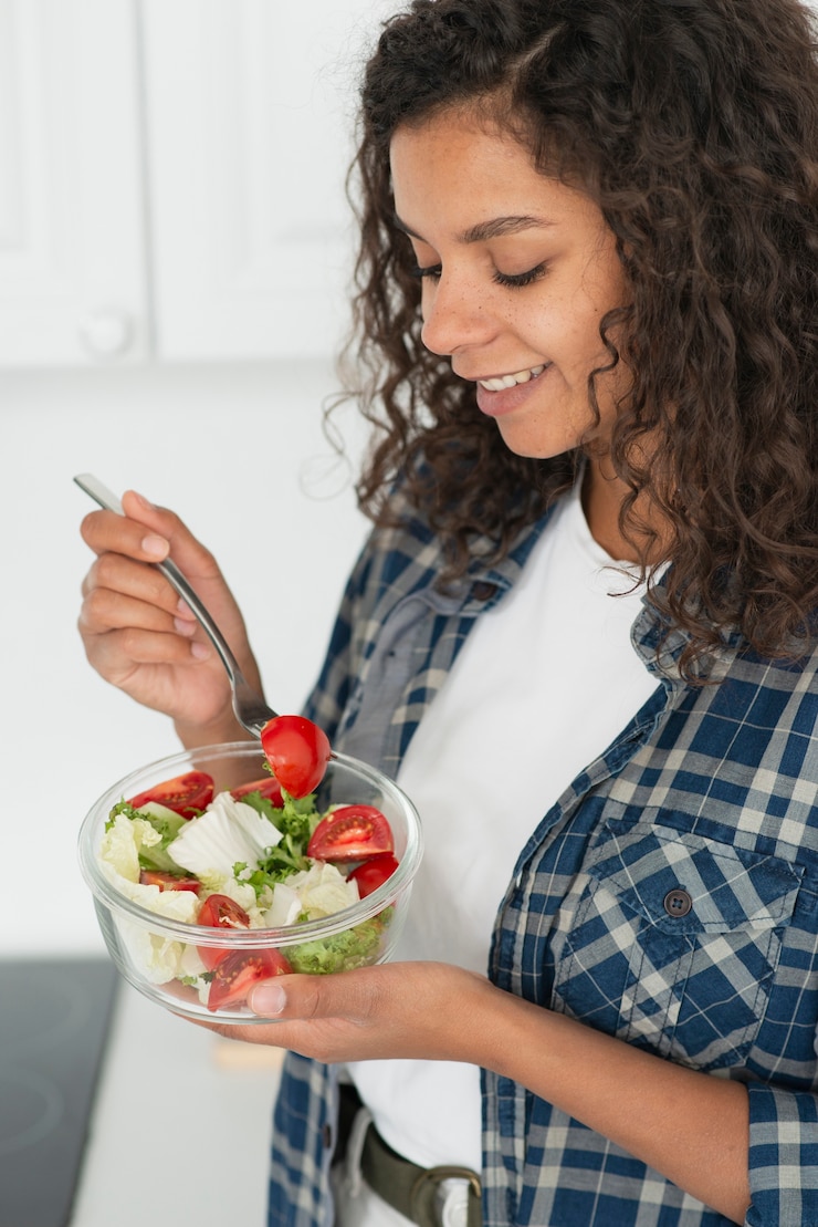 Free Photo afro american woman eating vegan salad