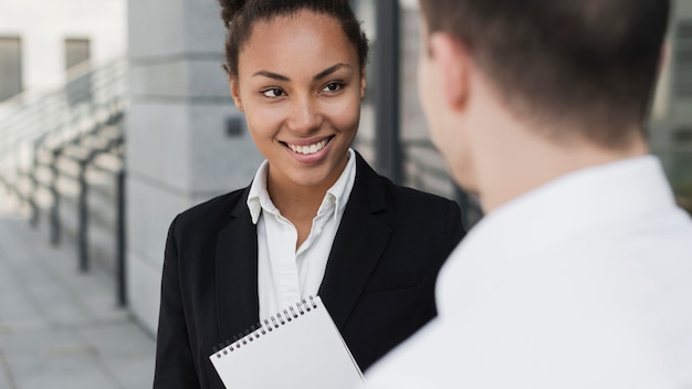 Afro american woman smiling at man