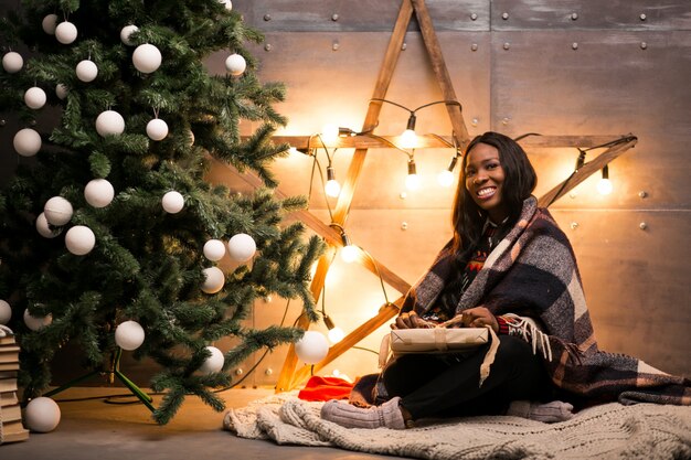 Afro american woman unpacking Christmas presents