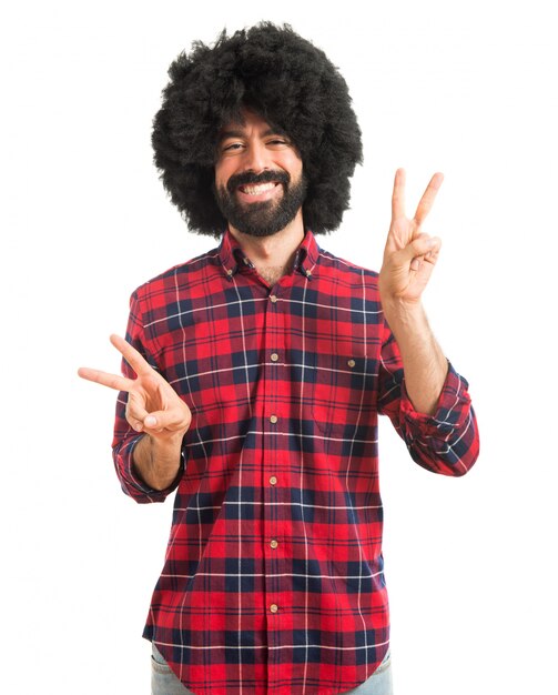 Afro man doing victory gesture