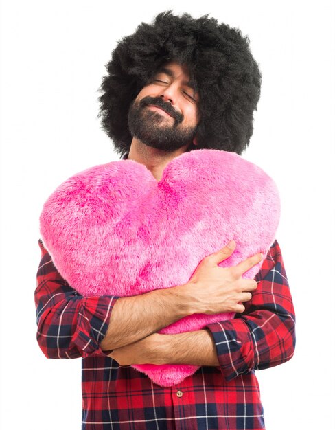 Afro man holding a big heart