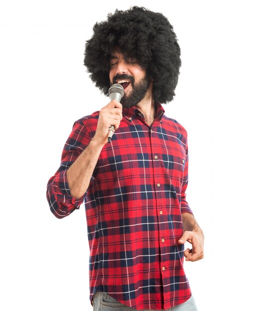 Afro man singing with microphone