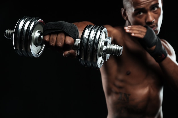 Free photo afroamerican boxer training with dumbbells