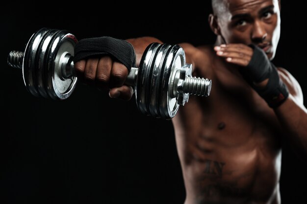 Afroamerican boxer training with dumbbells