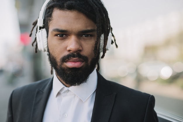 Free photo afroamerican businessman wearing headphones