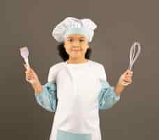 Free photo afroamerican chef holding cooking utensils