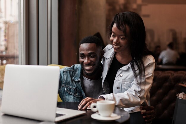 Afroamerican couple looking at laptop