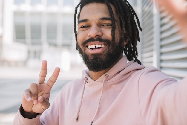 Free photo afroamerican man showing peace sign