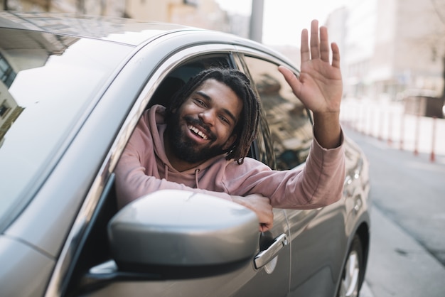 Afroamerican man waving medium shot