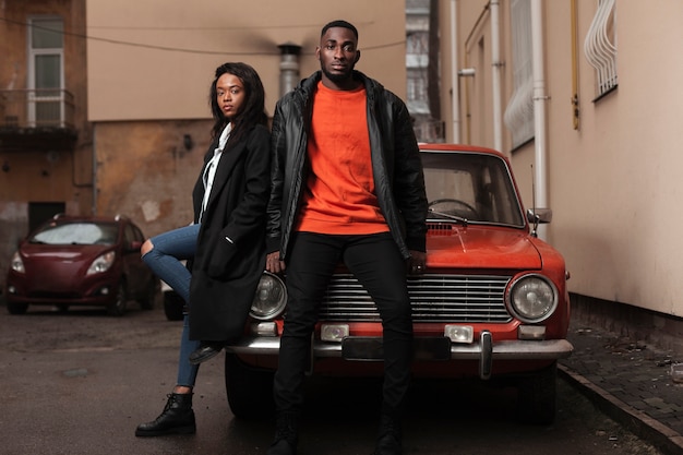 Free photo afroamerican models posing on car