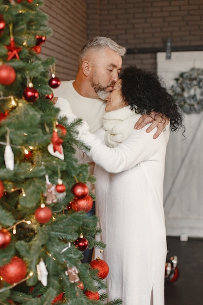 Age and people concept . senior couple at home. woman in a white knited sweater.