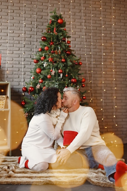 Age and people concept . Senior couple at home. Woman in a white knited sweater.