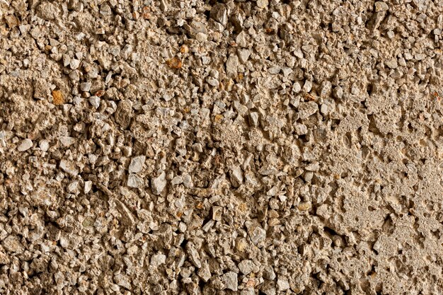 Aged cement surface with rocks and pebbles