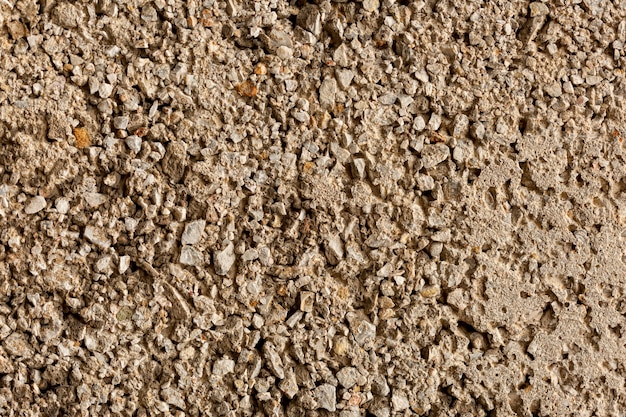 Aged cement surface with rocks and pebbles