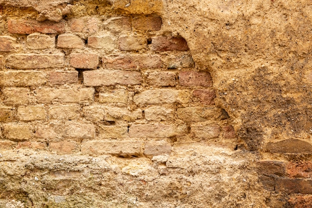 Aged concrete wall with bricks