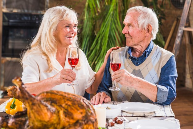 Free photo aged man and woman with glasses at table