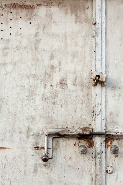 Aged metal surface with lock and holes