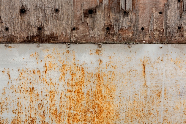 Aged metal with rust stains and chipping wood