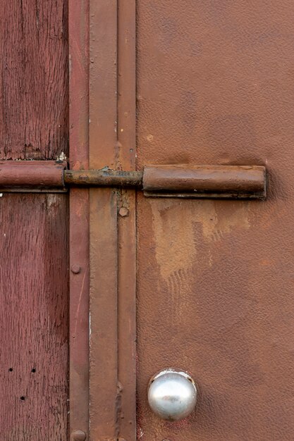 Aged metallic surface with rough wood and lock