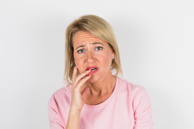 Aged sad lady in rose blouse