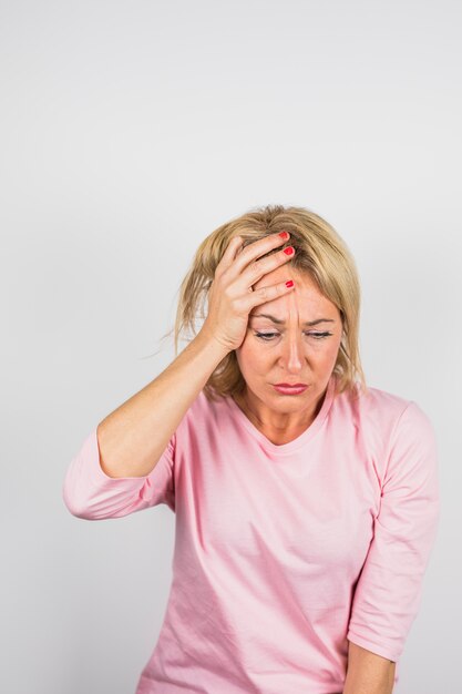 Aged sad woman in pink blouse