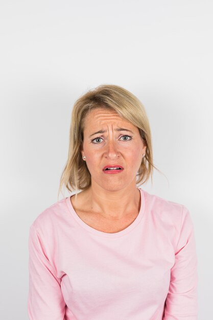 Aged sad woman in rose blouse