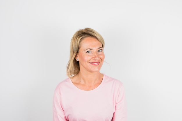 Aged smiling woman in rose blouse