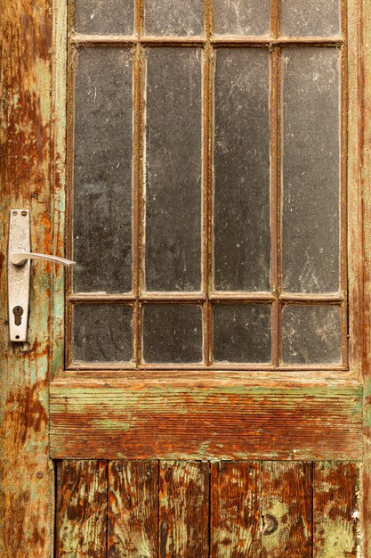 Aged vintage door with worn wood and glass