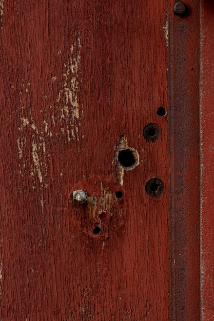 Free photo aged wood with holes and rusty metal