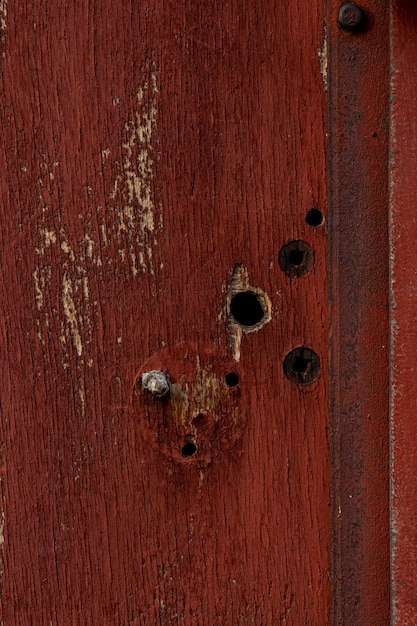 Aged wood with holes and rusty metal