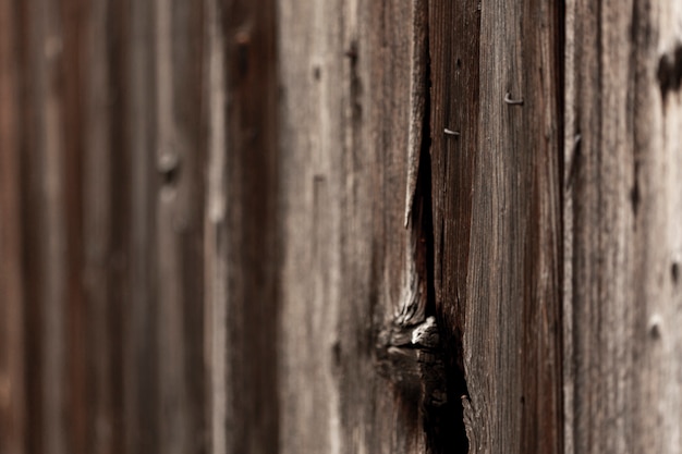 Aged wooden surface with knot and nails