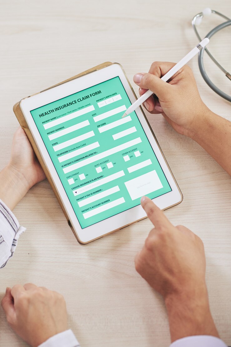Free Photo agent filling form of health insurance with patient