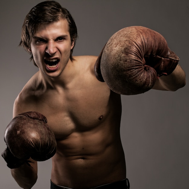 Agressive guy in a boxing gloves