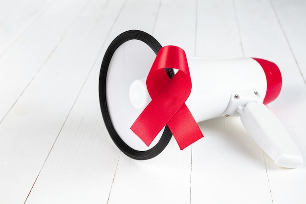 エイズ啓発はメガホンで赤いリボンに署名します