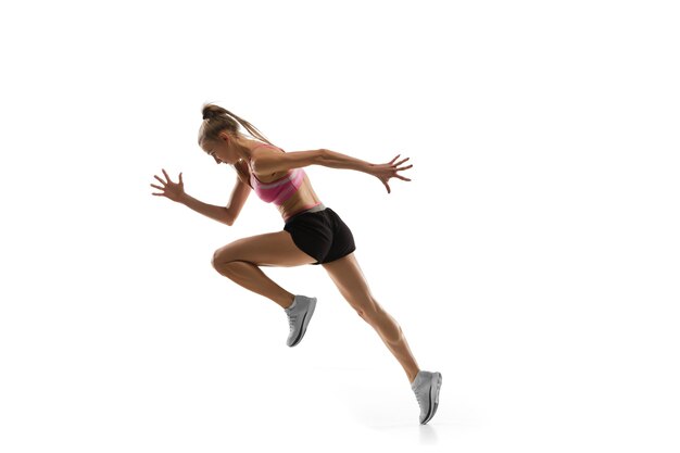 In air. Caucasian professional female athlete, runner training on white studio.