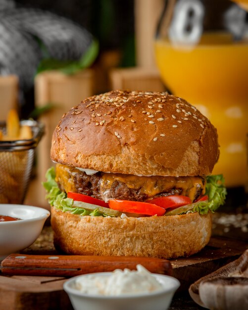 Air cheeseburger with meat on a wooden board