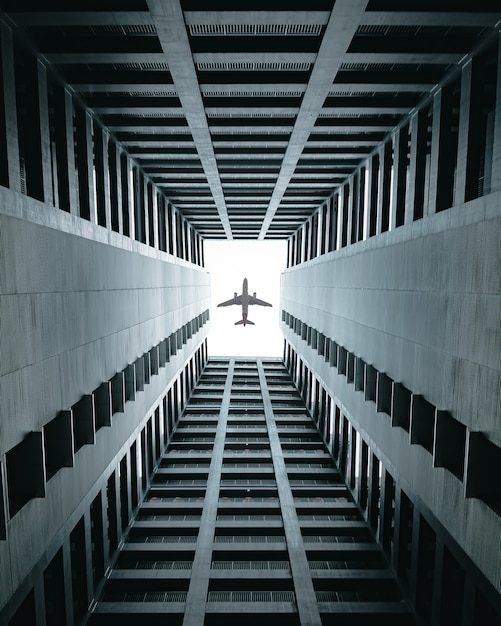 Airplane flying over the buildings.