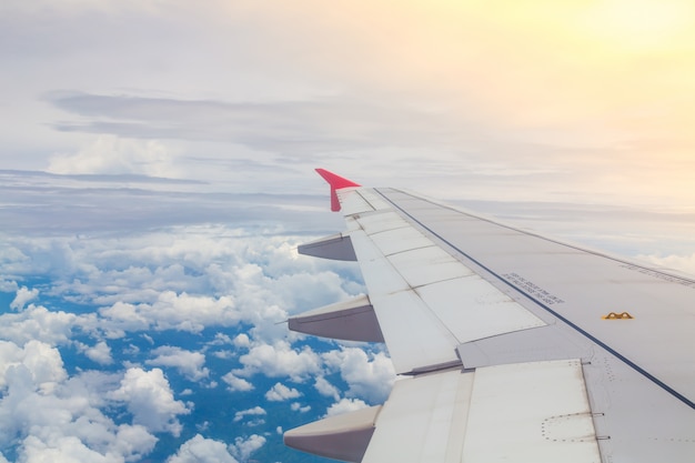 Free photo airplane flying above the clouds