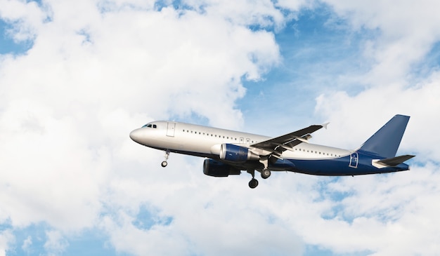 Airplane flying in a cloudy sky