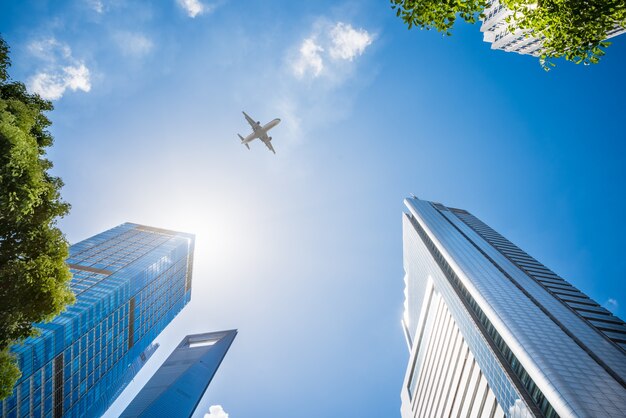 Airplane Flying Over Skyscrapers