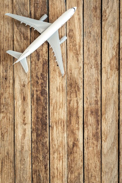 Airplane model on a wooden background top view copy space