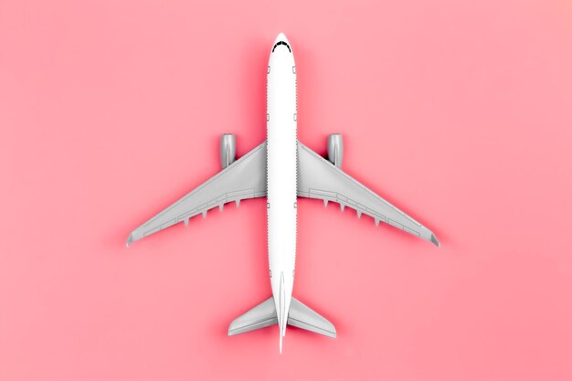 Airplane on a pink background flat lay travel concept