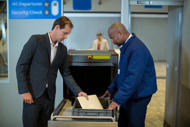 Airport security officer checking package of passenger