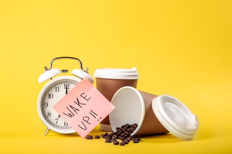 Free Photo alarm clock paper cup paper reminder and coffee beans on yellow background